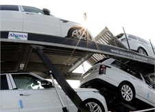 low angle shot of white Range Rover Sport's on an Acumen Logistics car transporter.